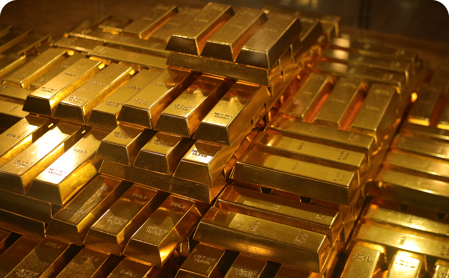 A pile of gold bars sitting on top of each other.